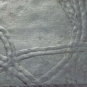Colour image of gray rock with darker gray winding trail